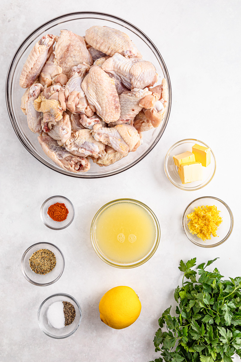Lemon pepper chicken wings ingredients in bowl on counter.