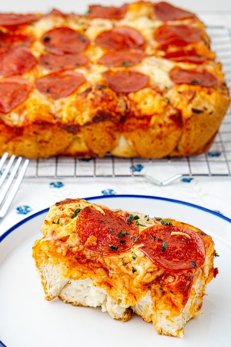 Bubble up pizza bake with biscuits served on a plate.