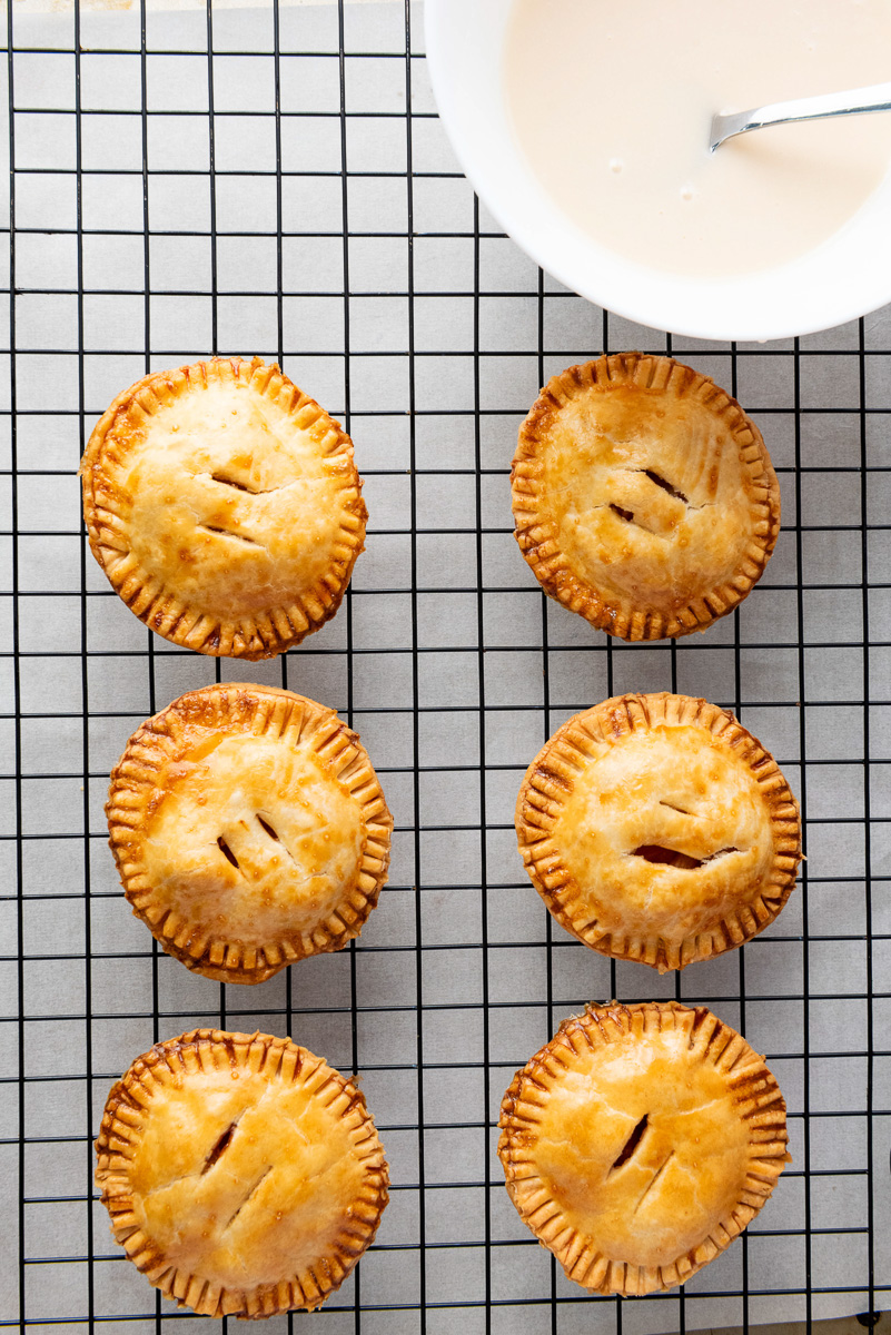 Apple hand pies on wire cooling rack.