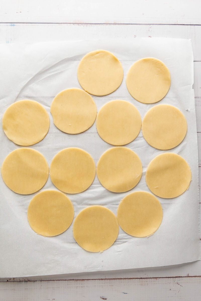 Pie dough is cut into circles.