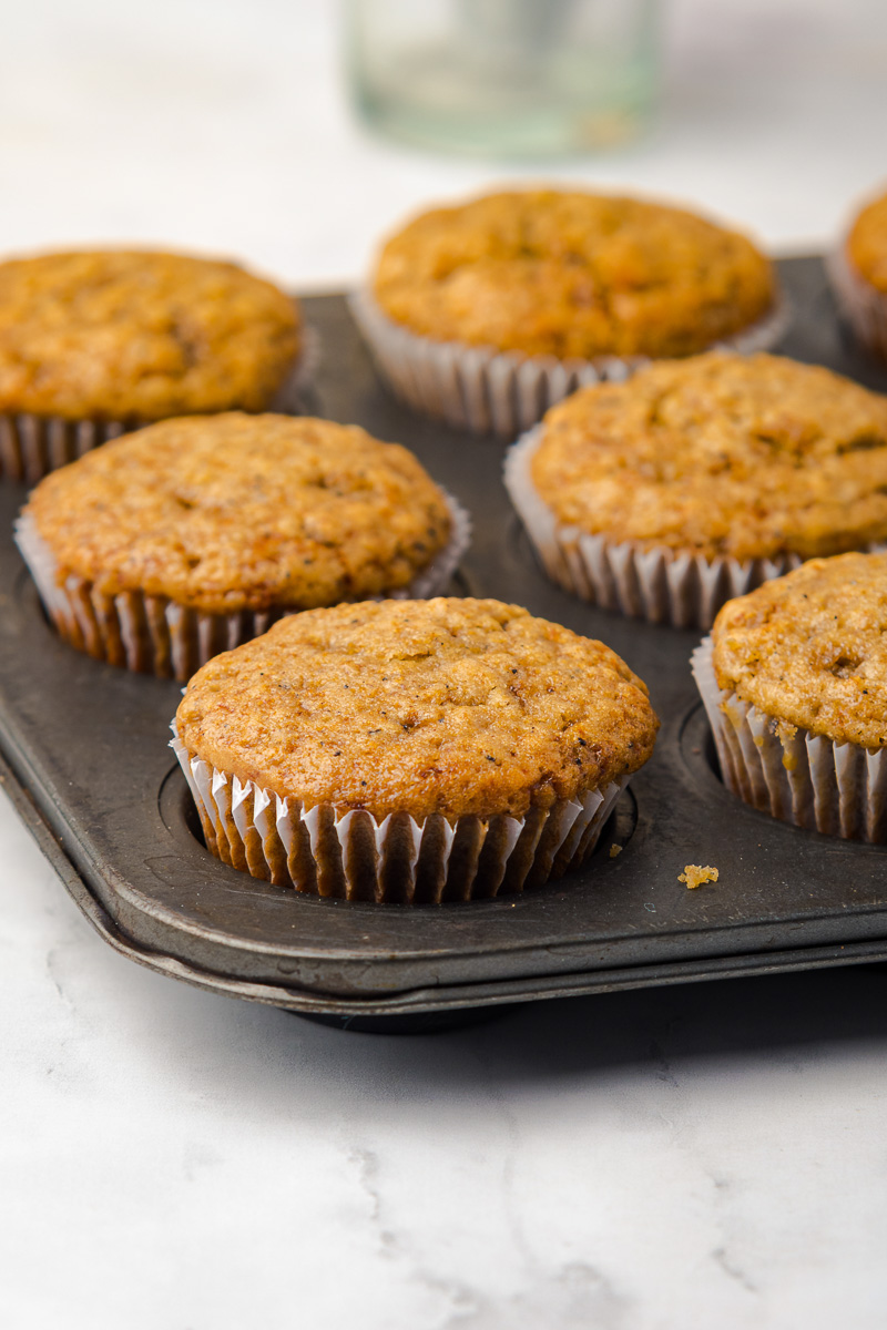 Baked cupcakes in paper liners in pan.