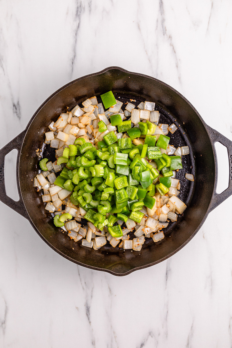 ONions and peppers in skillet.