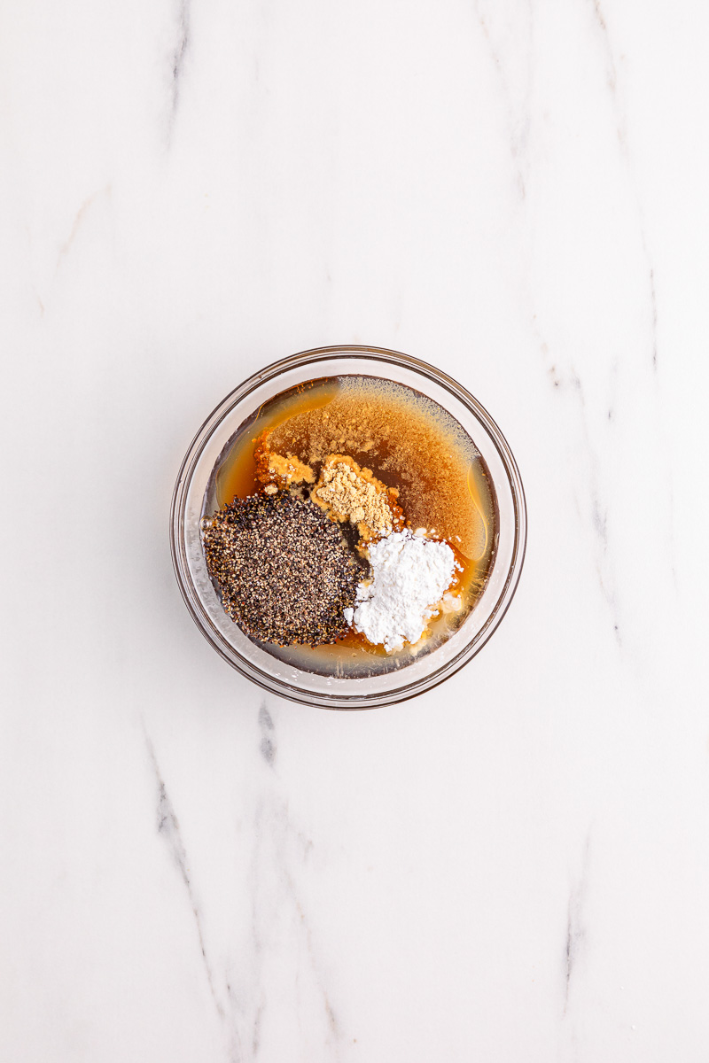 Sauce mixture in glass mixing bowl.