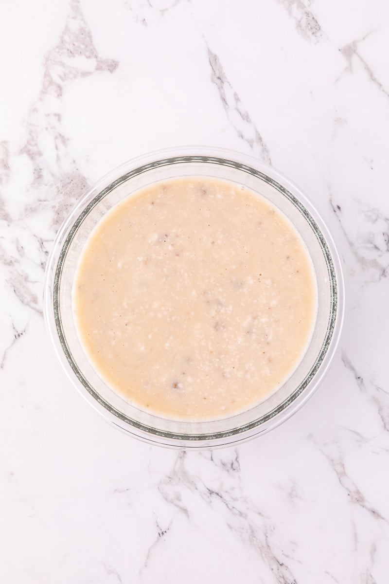 Mushroom soup and chicken broth in glass bowl.