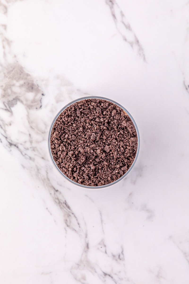 Crushed oreo cookies in bowl.