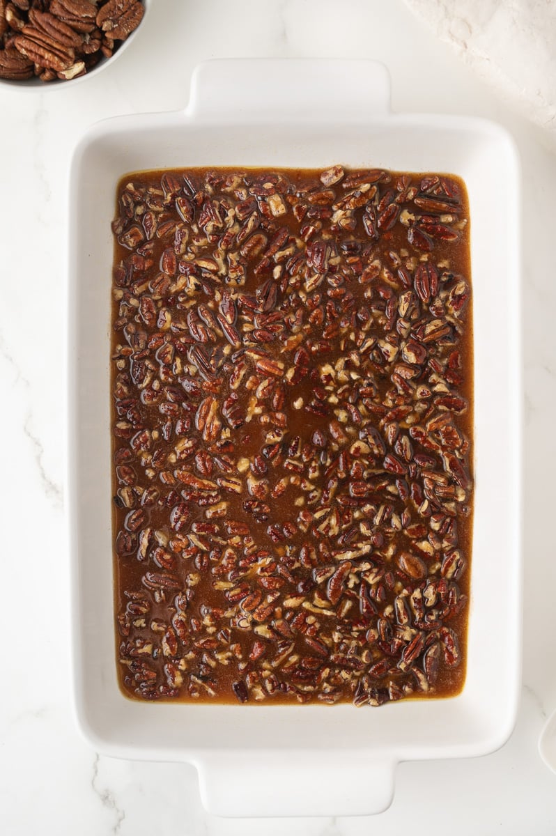 Pecan mixture is spread into the bottom of a 9x13-inch baking dish.