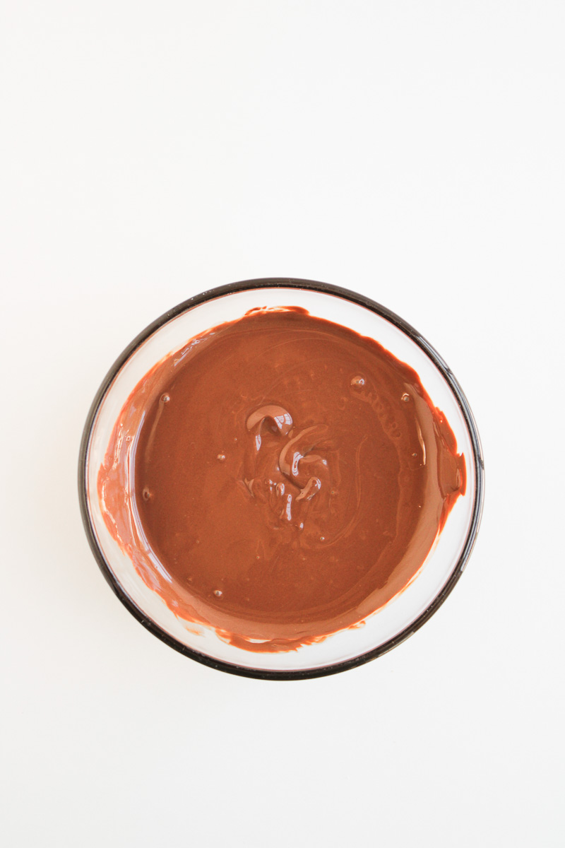Melted chocolate in glass bowl.