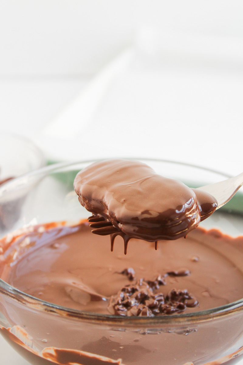 Nutter Butter cookies are dipped in melted chocolate.