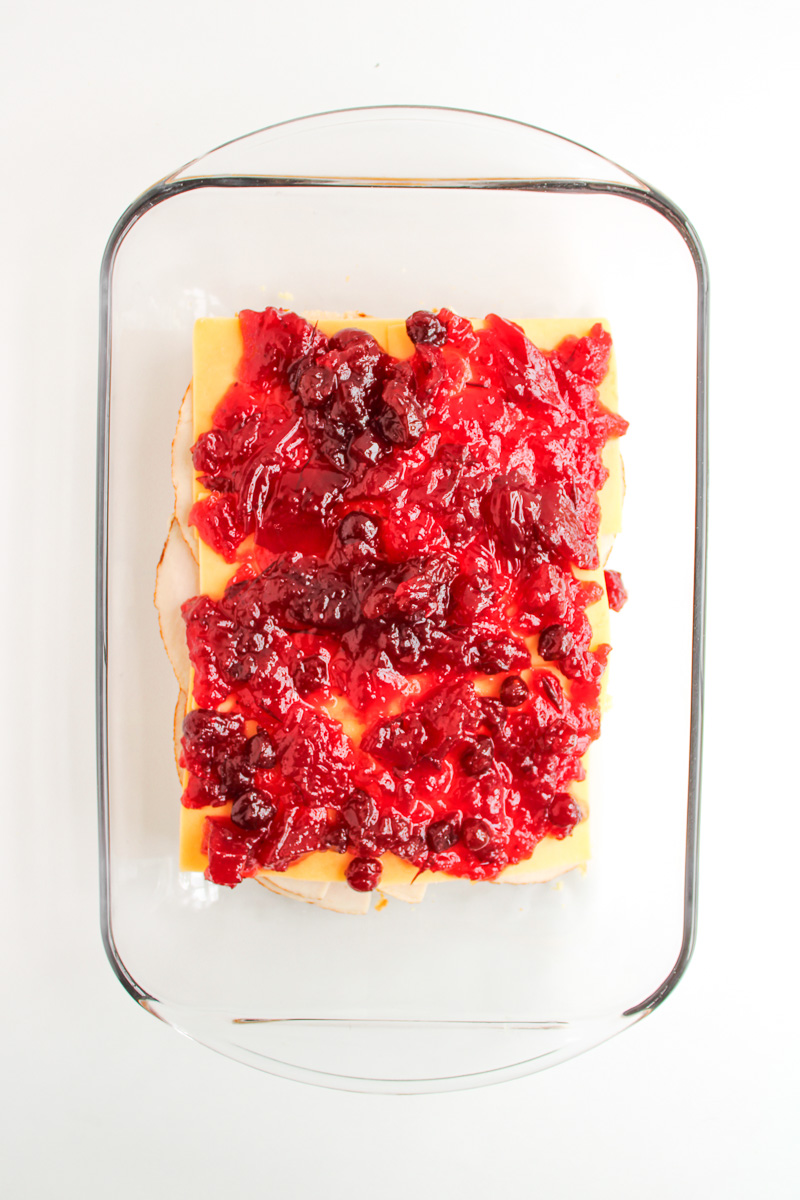 Cranberry sauce is spread on top of the cheese layer.