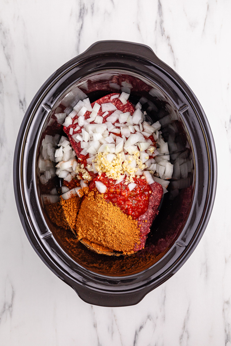 Ingredients for slow cooker taco meat in crockpot.
