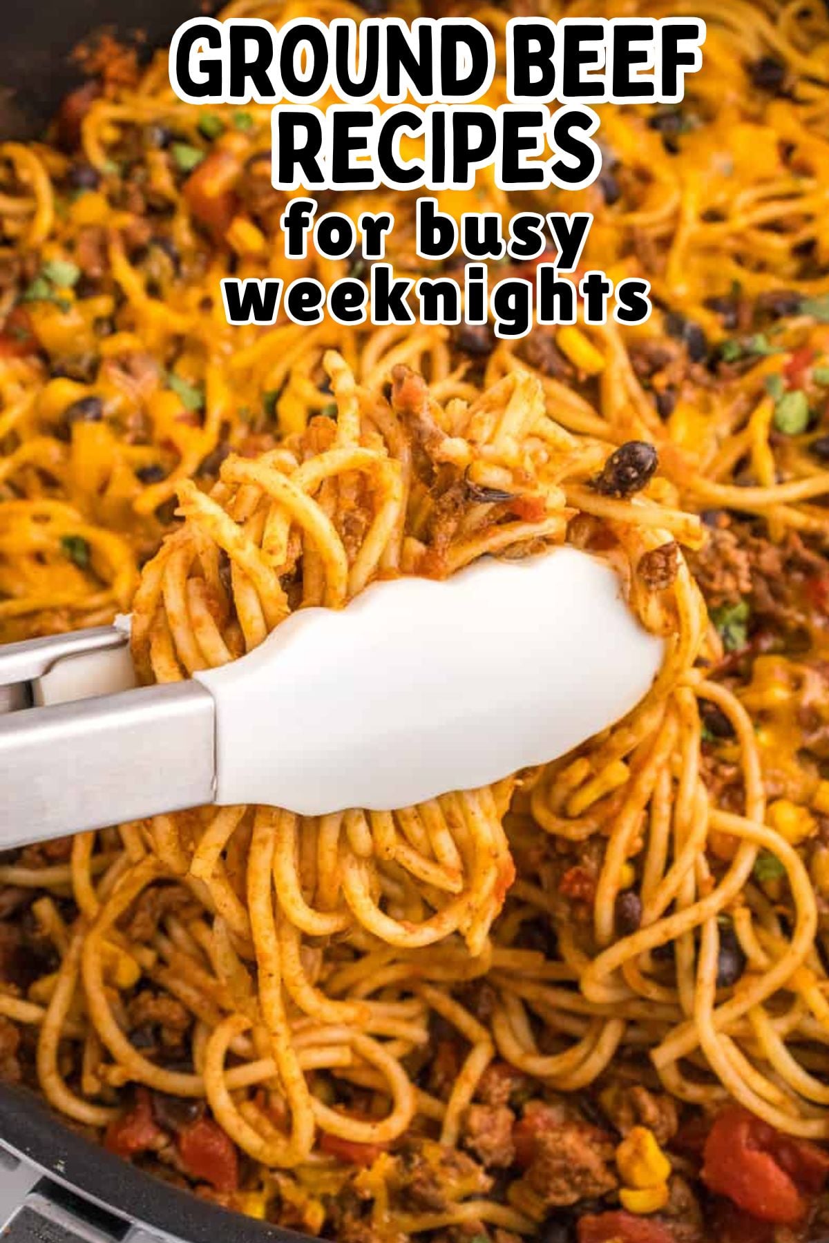 Taco spaghetti scooped up with tongs.