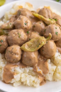 Meatballs served on a bed of mashed potatoes.
