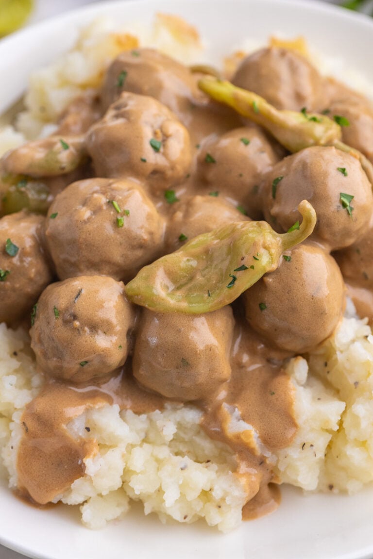 Meatballs served on a bed of mashed potatoes.