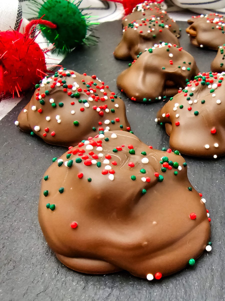 Holiday caramel pecan clusters on wooden board.