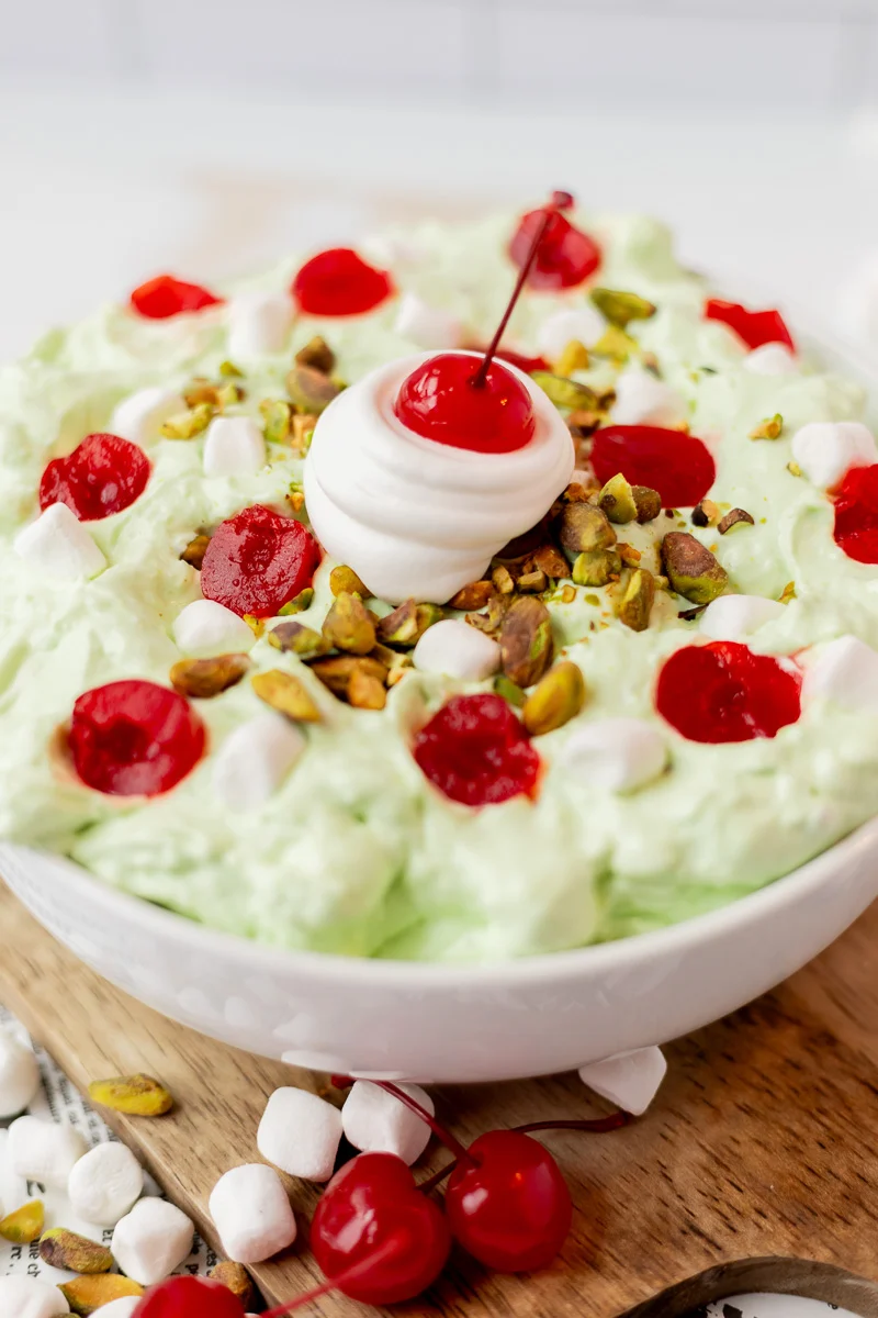 White bowl with pistachio fluff salad or Watergate salad thats perfect for Thanksgiving tables.