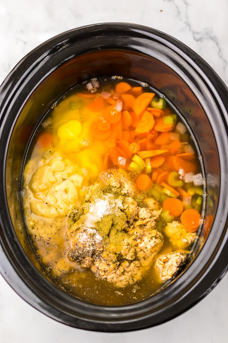 Ingredients are added to the slow cooker.