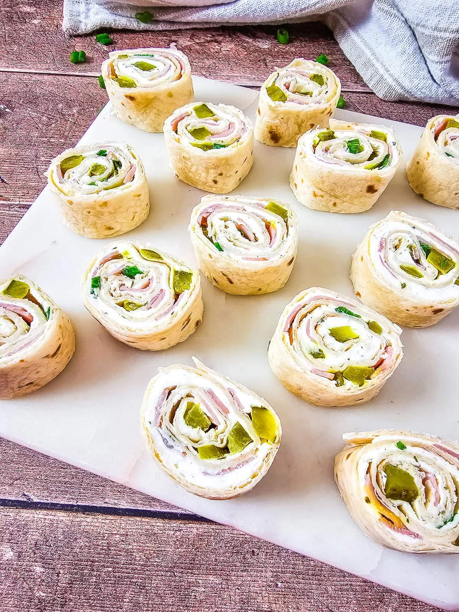 Dill pickle pinwheels on a piece or parchment paper.