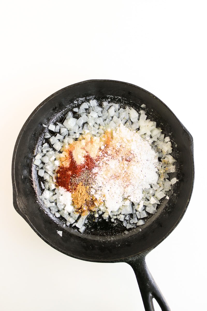 Flour and seasonings are added to the skillet along with the onions.