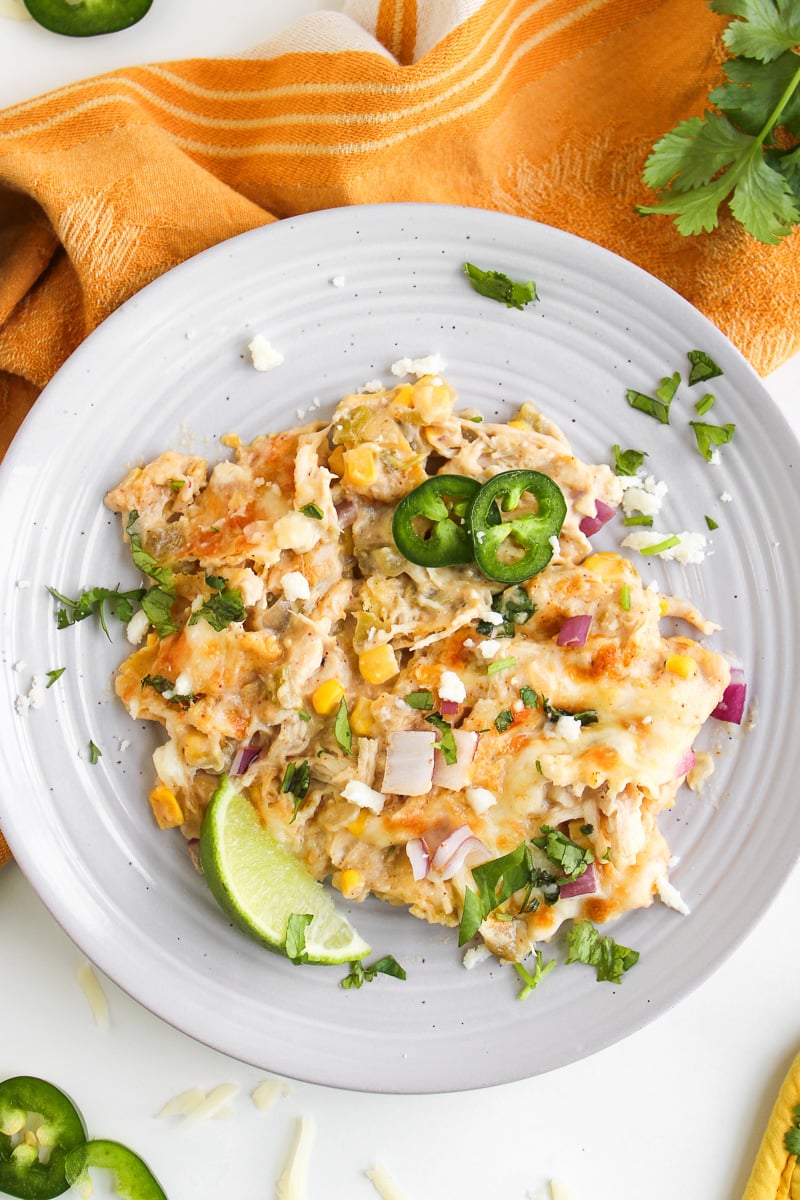 White chicken enchilada skillet served on a plate.