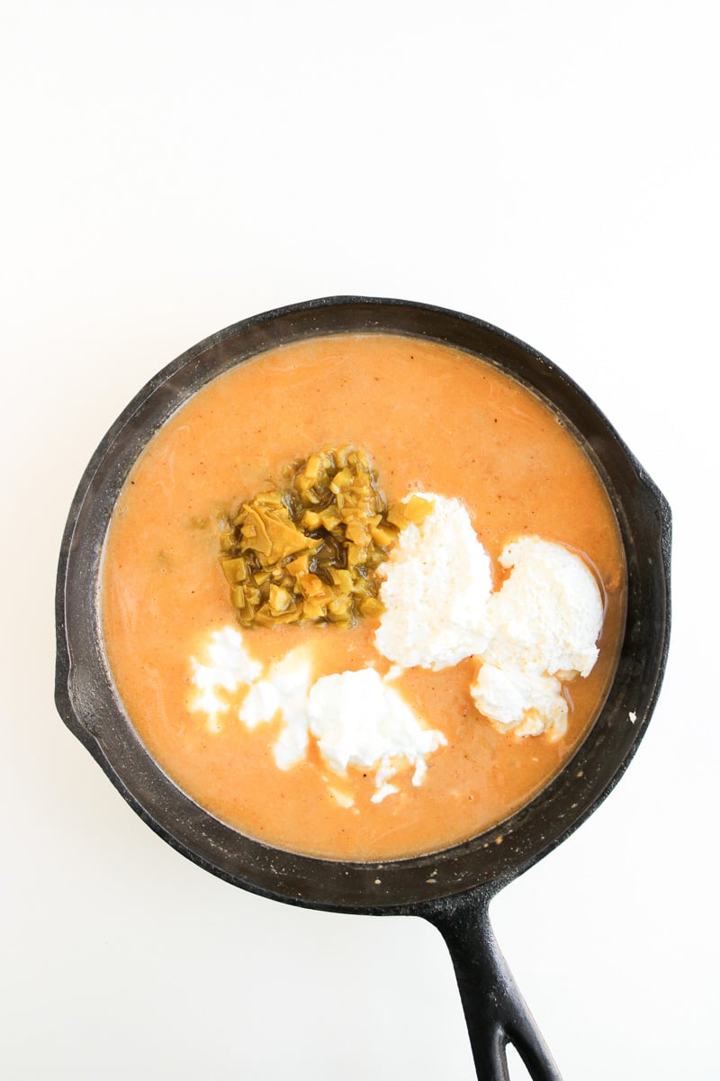 Greek yogurt and green chiles are added to the skillet.