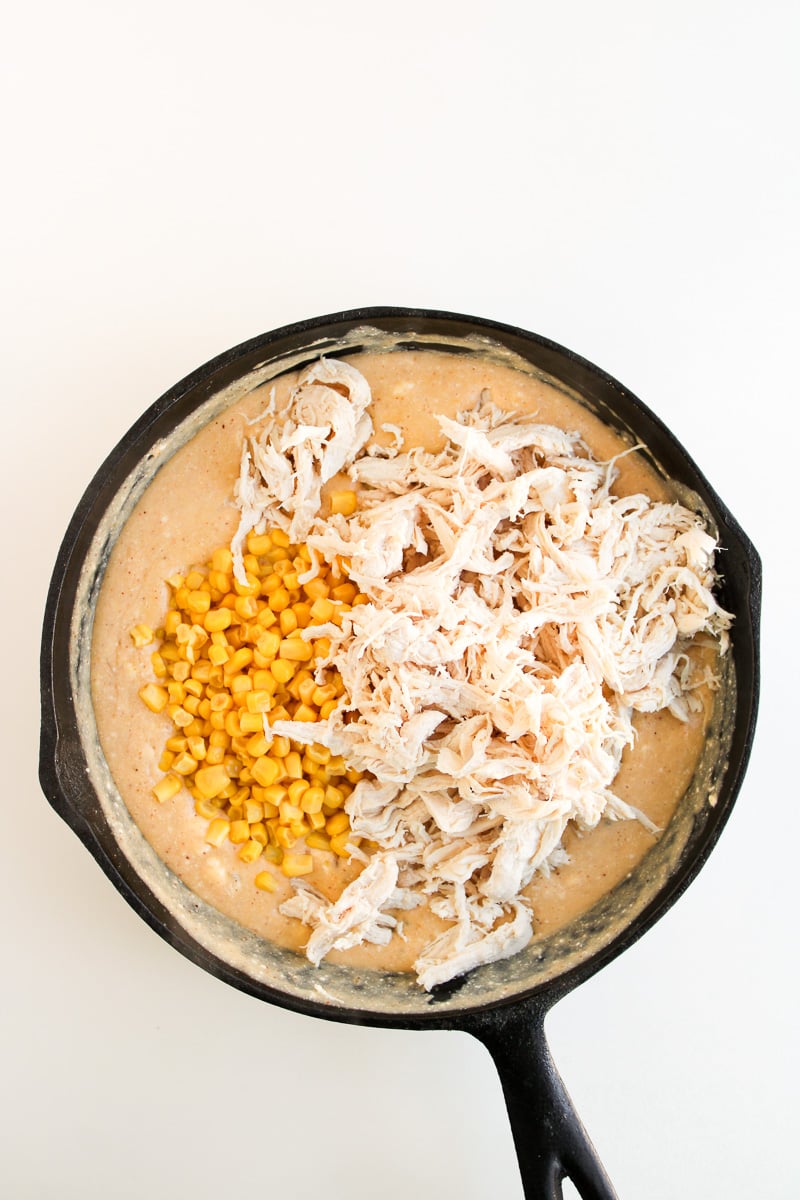 Chicken and corn are added to the skillet.