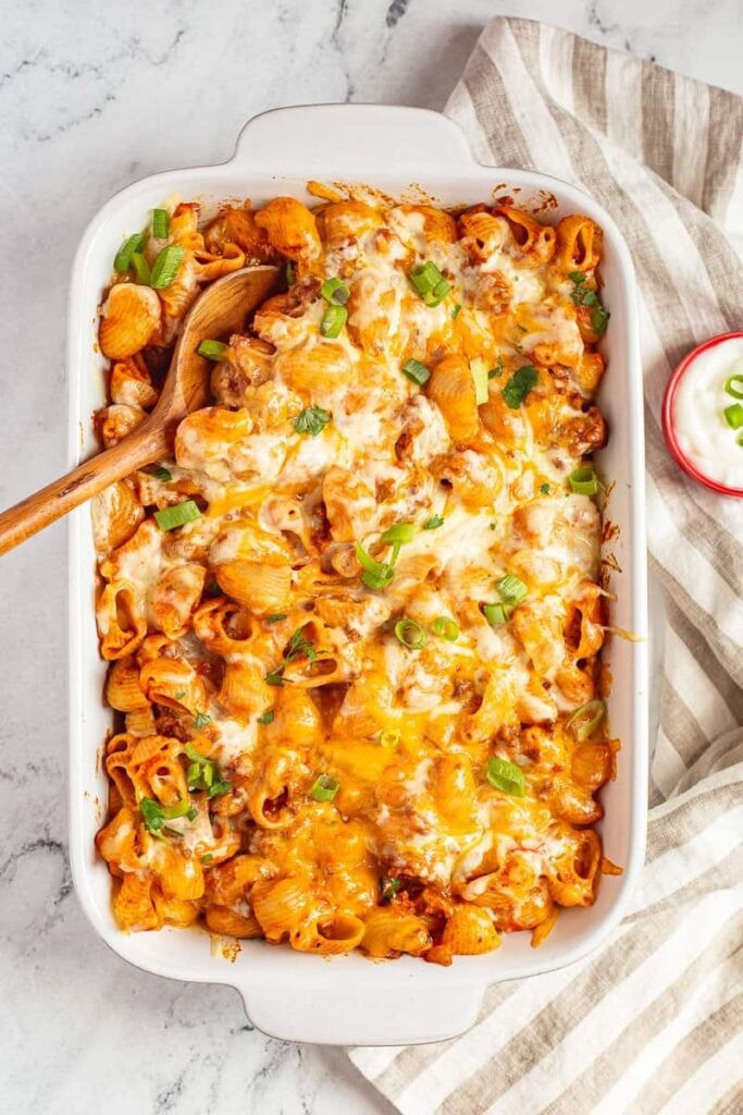 Overhead view of cheesy taco pasta in baking dish ready to be served.