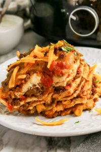 Crockpot taco casserole served on a white plate.