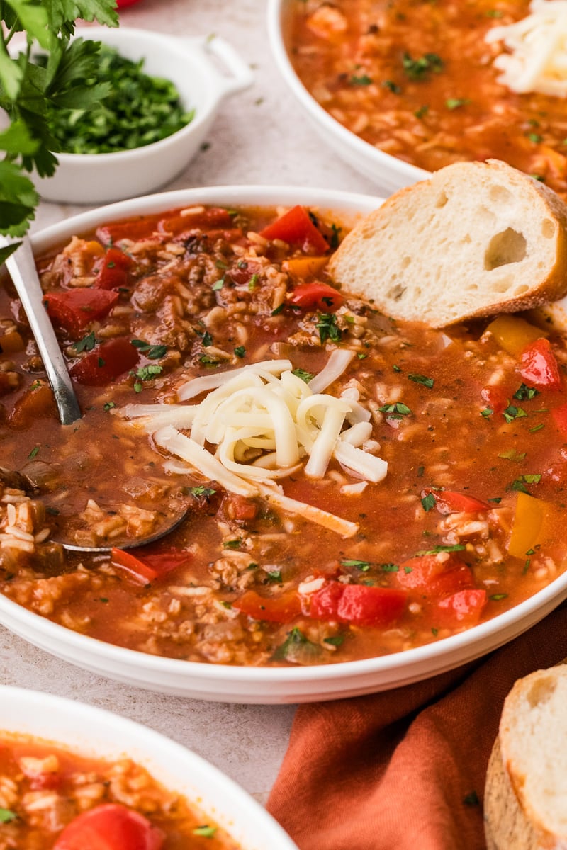 Crockpot stuffed pepper soup in a bowl garnished with mozzarella cheese.