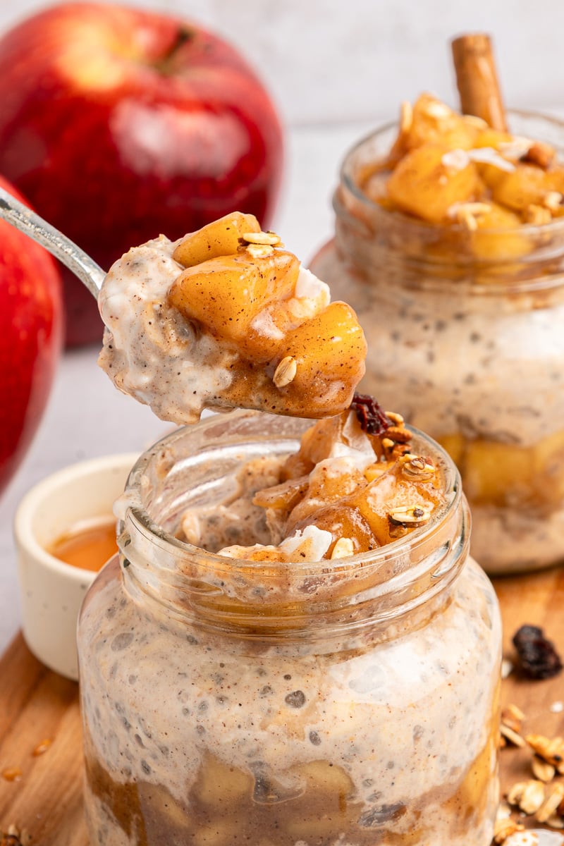 Close up view of apple pie overnight oats on a spoon.