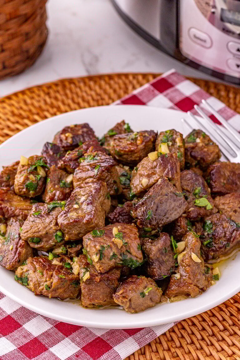 Garlic butter steak bites served on a white plate.
