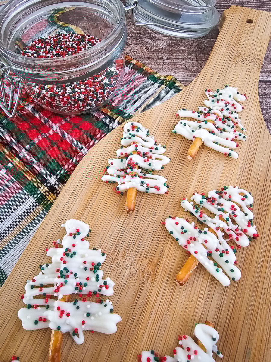 White chocolate Christmas trees on a wooden board.