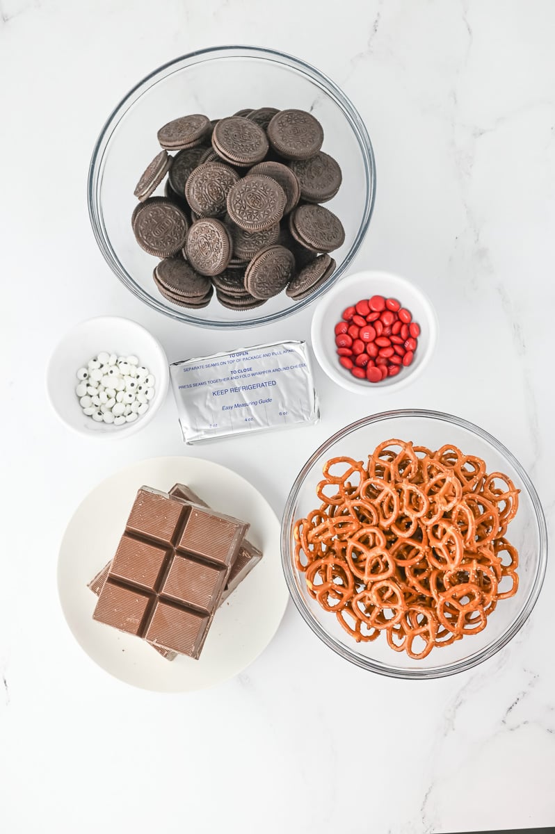 Ingredients for reindeer oreo cookies in small bowls on counter.