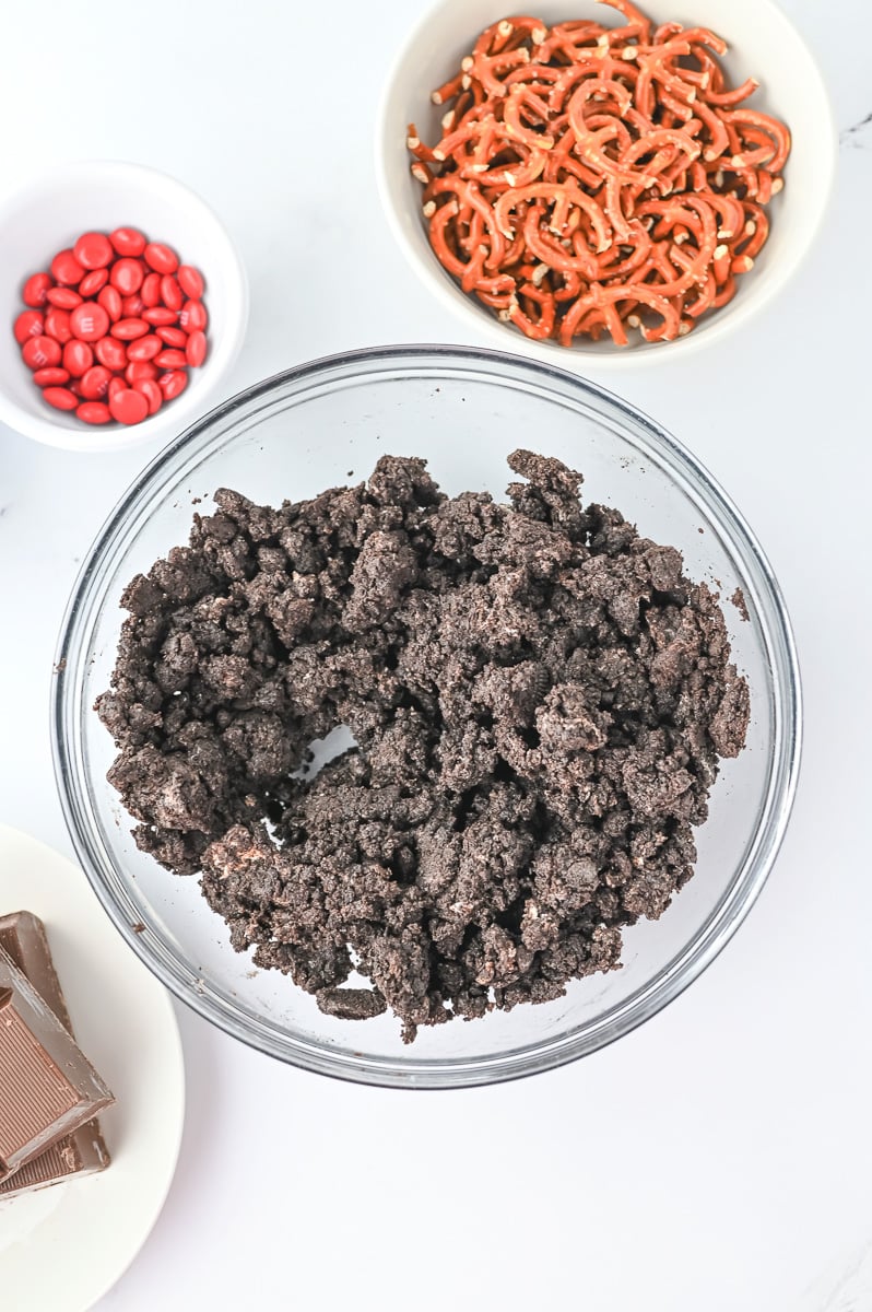 Cream cheese is added to Oreos in bowl.