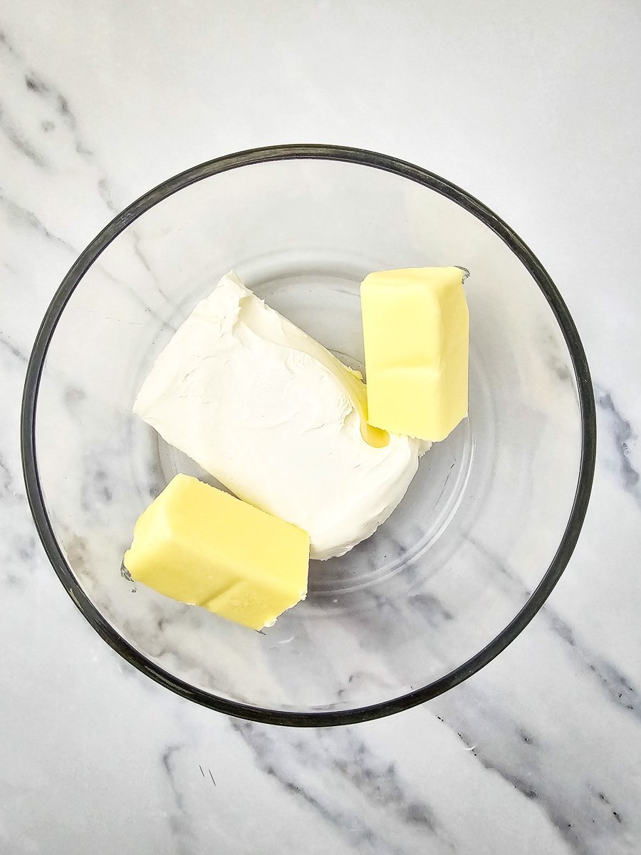 Cream cheese and butter in mixing bowl.