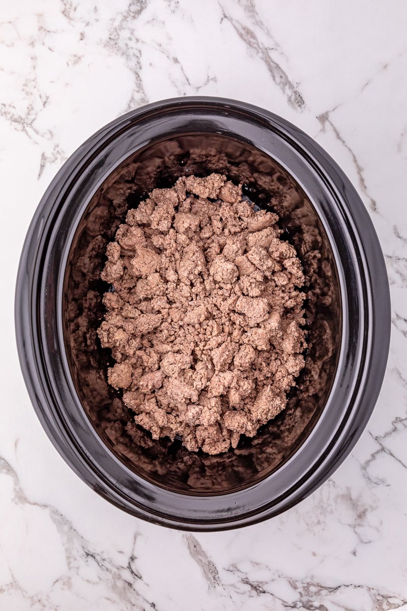 Cooked ground beef is added to the crockpot.