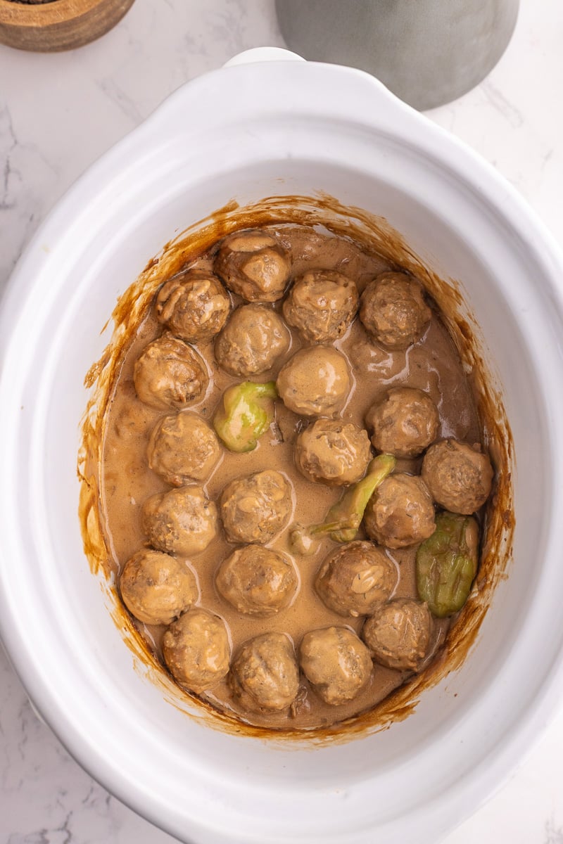 Finished dish of cooked meatballs in crockpot.