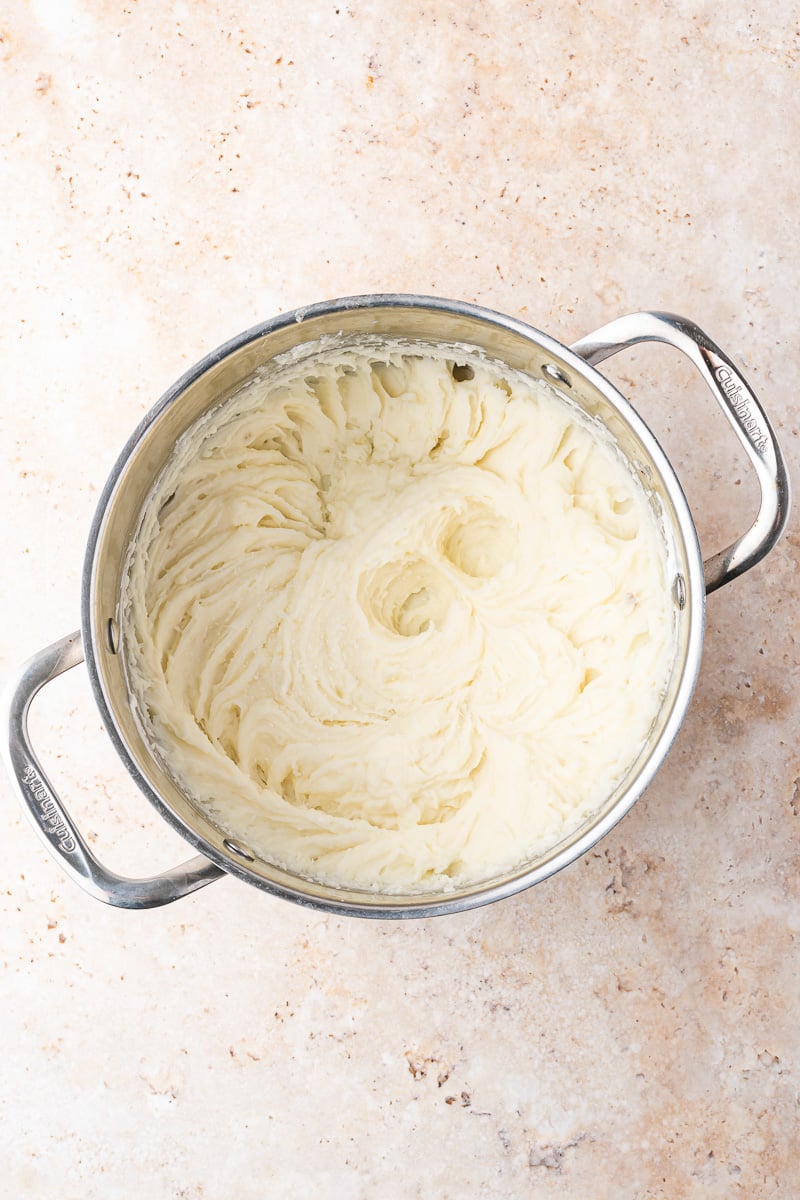 Mashed potato in a pot, ready to be added to the slow cooker.