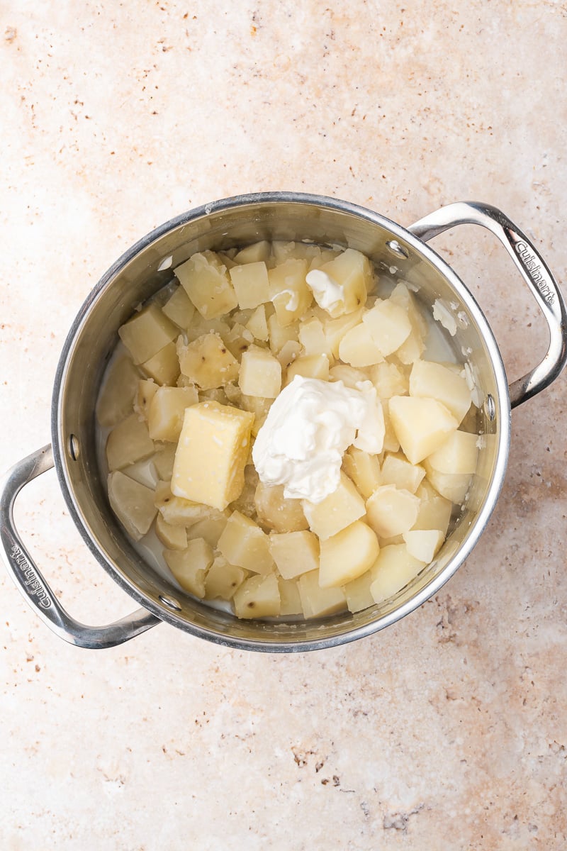 Potatoes with butter and sour cream in a pot.