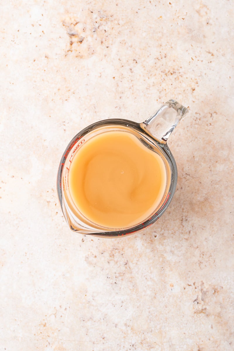 Cornstarch and beef broth in measuring cup.