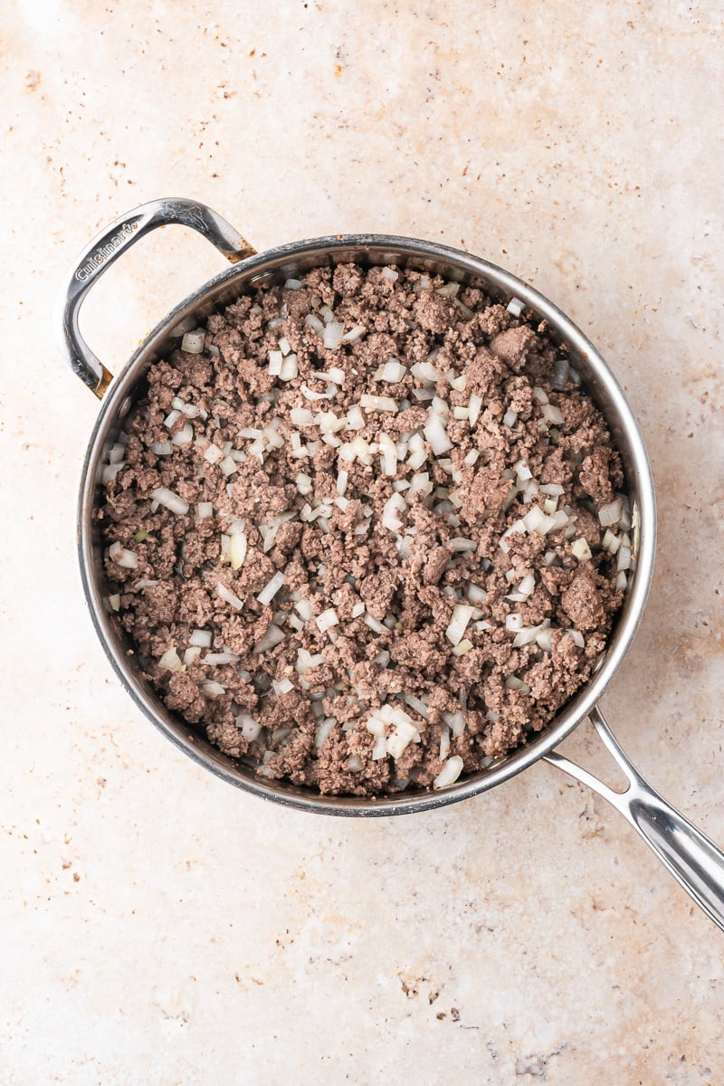 Cooked ground beef oinions and garlic in skillet.