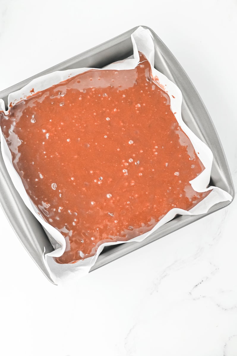 Uncooked brownie batter in baking dish.