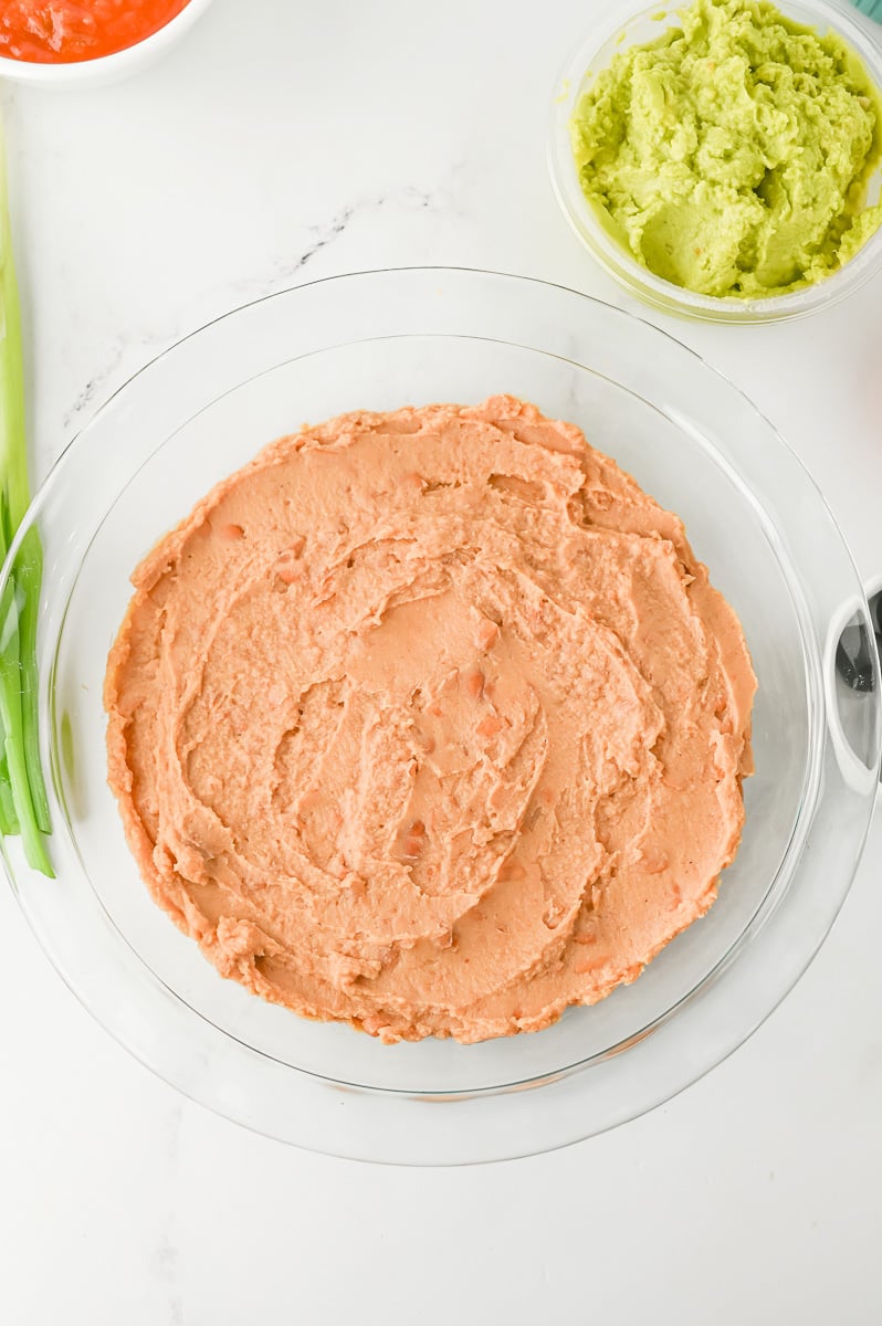 Black beans are spread out evenly in bottom of pie plate.
