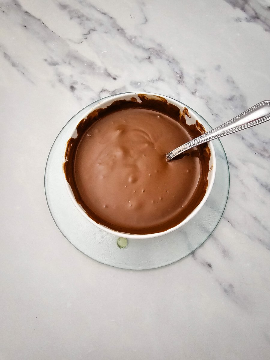 Melted chocolate wafers in bowl.