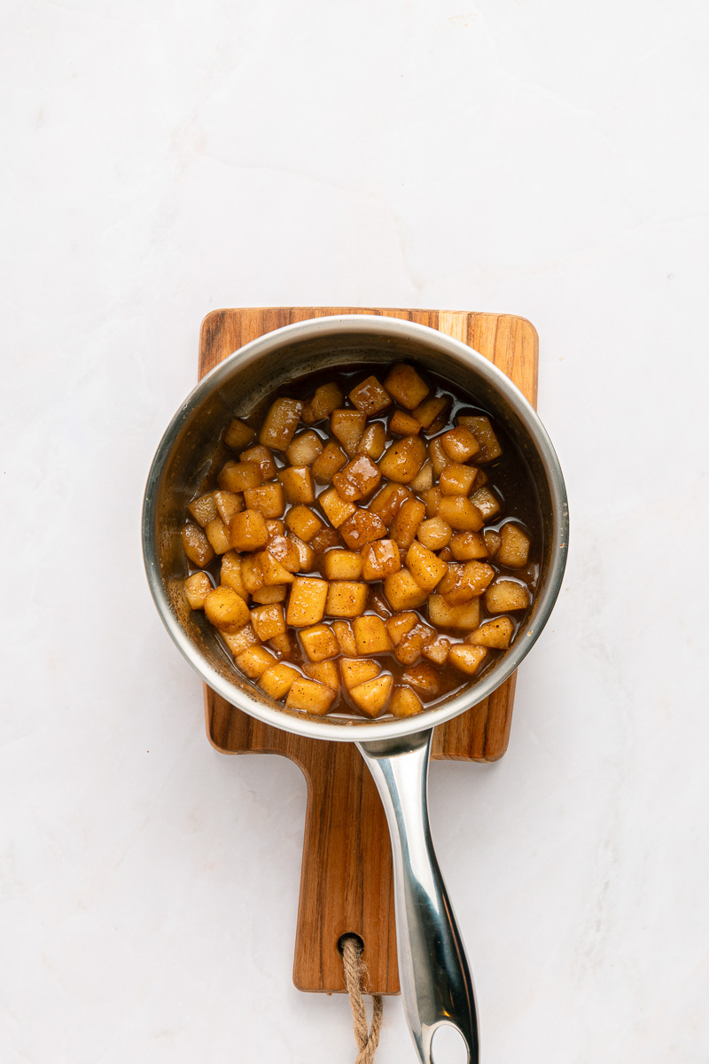 Cooked apples in saucepan.