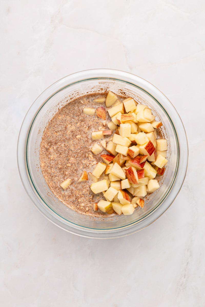 Ingredients for apple pie overnight oats in small bowl.