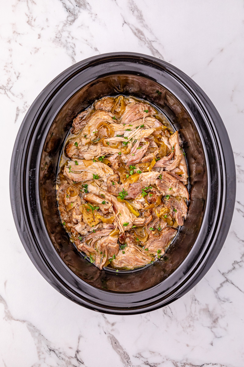 Overhead slow cooker pork roast in crockpot after cooking.