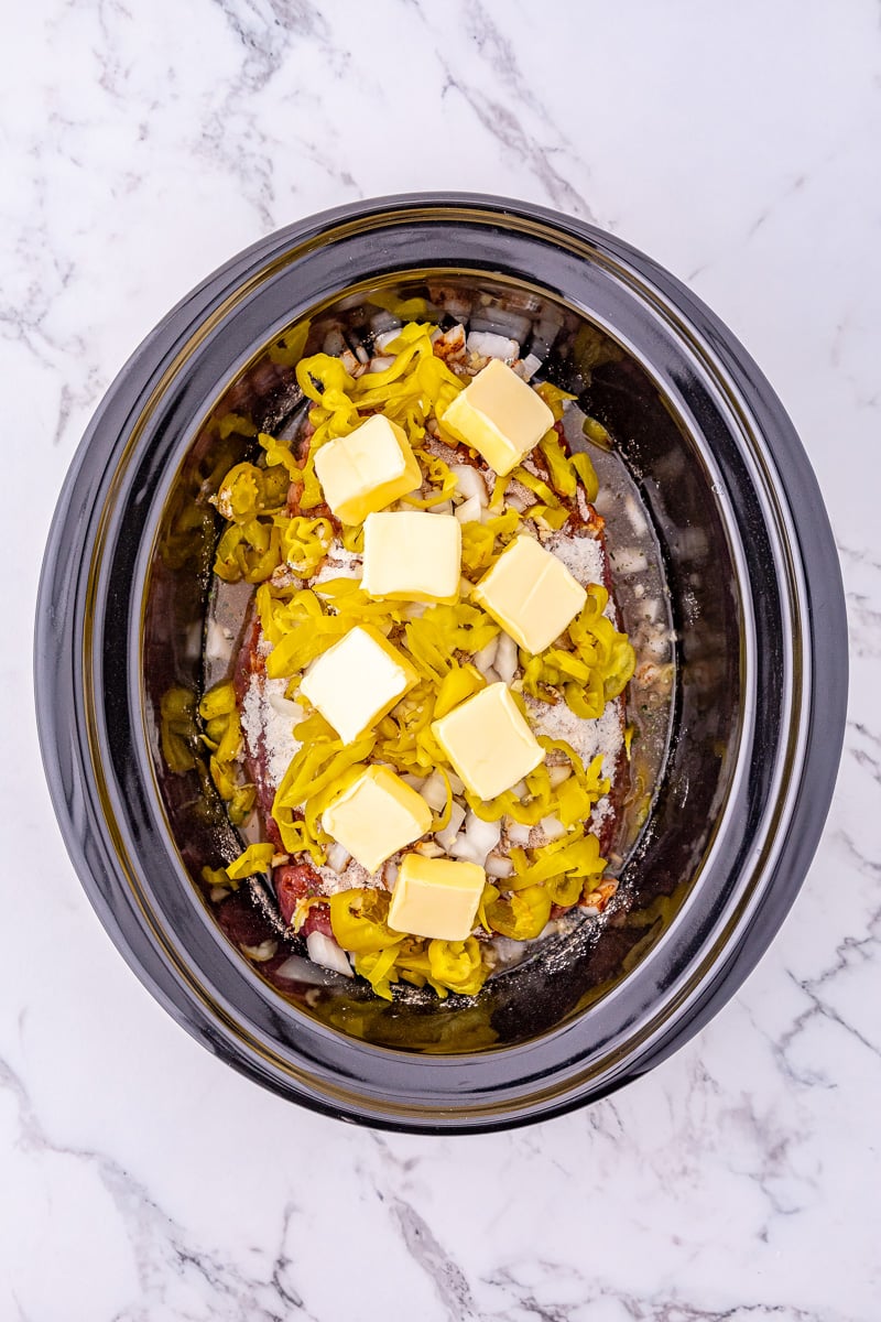 Remaining ingredients are added to the top of the pot roast in crockpot.