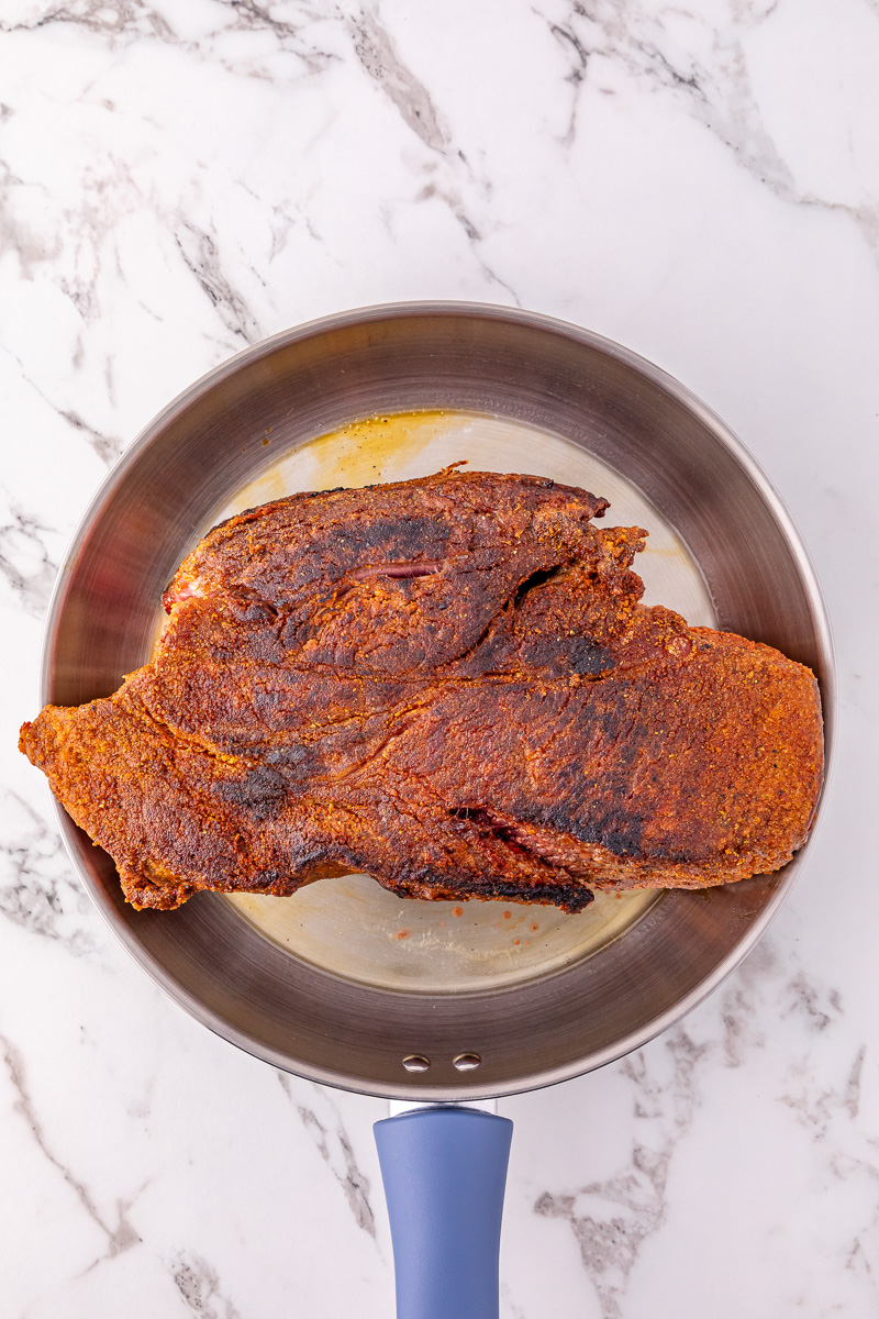 Seared pot roast in skillet.