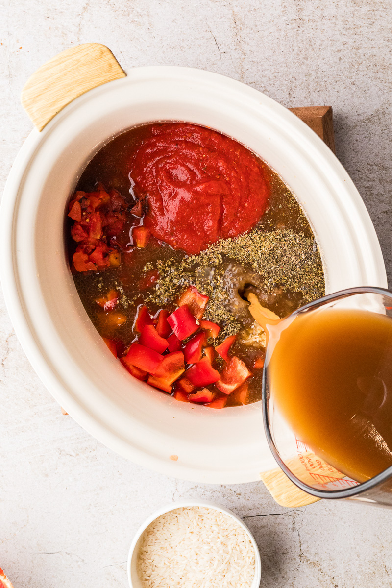 Beef broth is added to skillet.