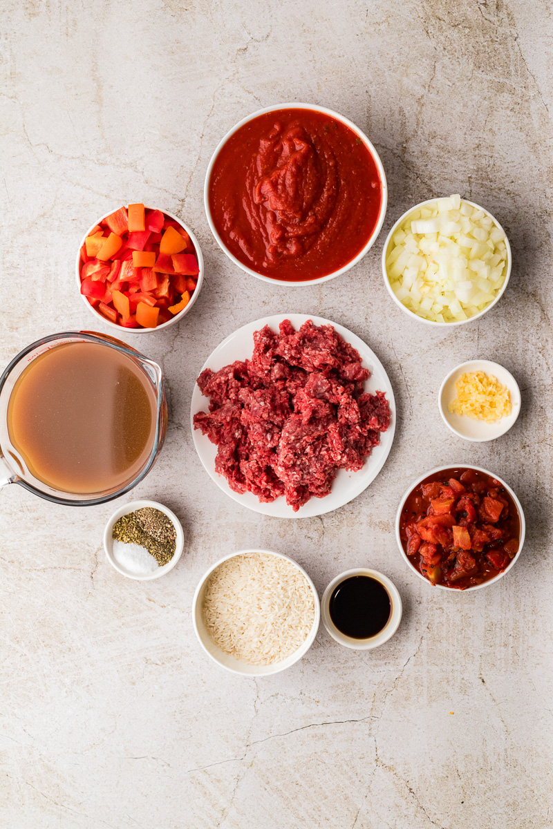 Ingredients for stuffed pepper soup laid out on counter in small bowls.